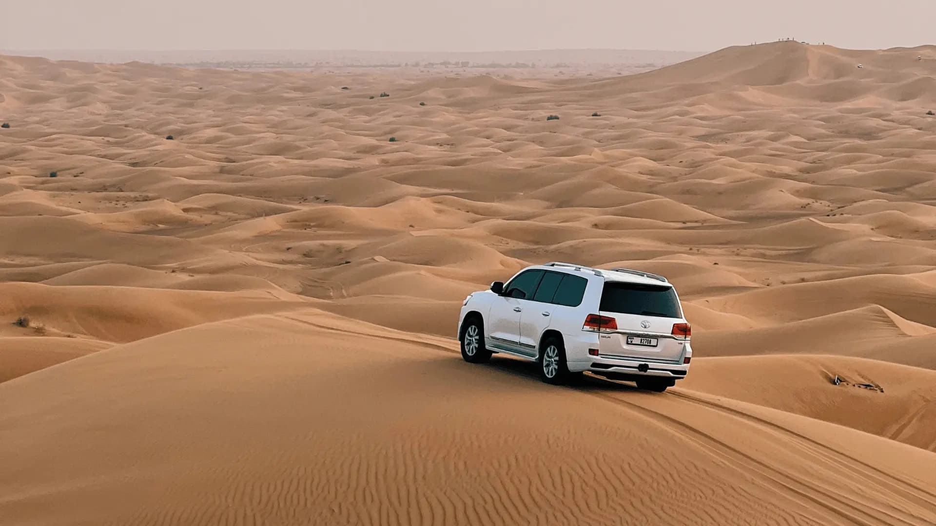 Land Cruiser dune bashing in Dubai desert safari with golden sand dunes